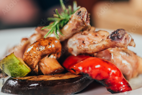 Fototapeta Naklejka Na Ścianę i Meble -  close-up view of gourmet grilled chicken with mushroom, pepper, rosemary, zucchini and eggplant