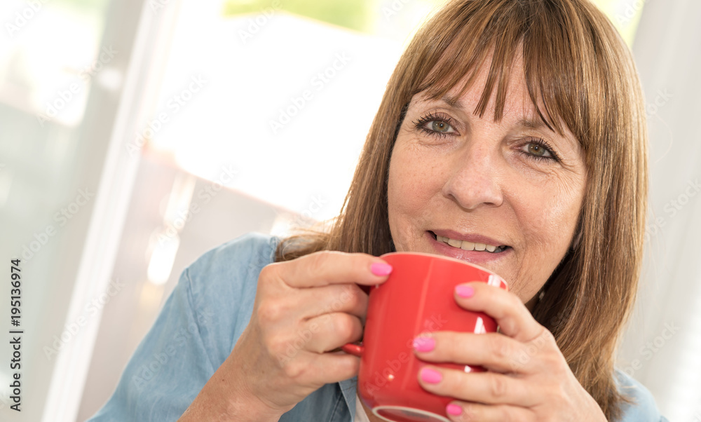 Mature woman during coffee break at home Mature woman during coffee break at home