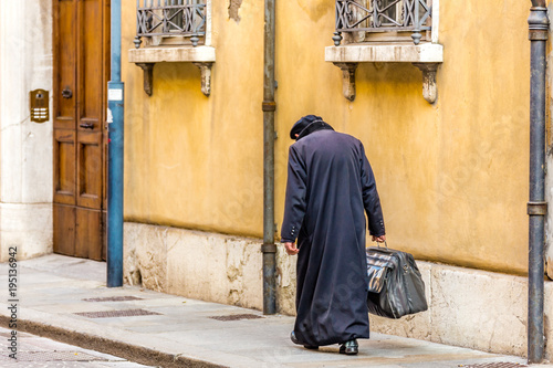 hunched back man walking
