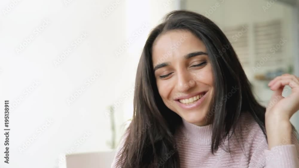 Attractive brunette woman portrait touching her hair sitting in a cafe Attractive brunette woman portrait touching her hair sitting in a cafe