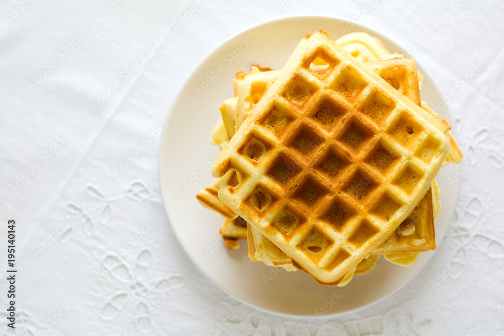 Healthy breakfast. Belgian waffles with butter, blueberry and nuts on white tablecloth. Selective focus Healthy breakfast. Belgian waffles with butter, blueberry and nuts on white tablecloth. Selective focus