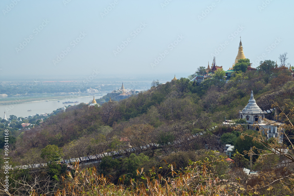 View of the Irrawaddy (or Ayeyarwady or Ayeyarwaddy) River and pagodas and stupas on the Sagaing Hill in Mandalay, Myanmar (Burma) on a sunny day.