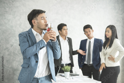 Billede på lærred businessman happy pride with win cup and business team jealous behind