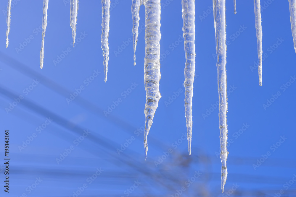 The frozen water turned into icicles hanging from the roof The frozen water turned into icicles hanging from the roof