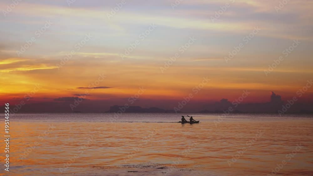 Silhouette of couple kayaking at amazing sunset. Slow motion. Healthy way of living, sport. 3840x2160 Silhouette of couple kayaking at amazing sunset. Slow motion. Healthy way of living, sport. 3840x2160