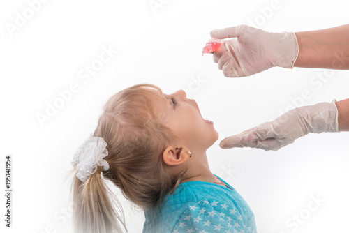  a child being treated for influenza, the child takes the medicine in the hospitalception at the doctor takes antipyretic, anti-flu, the child takes the medicine in the hospital