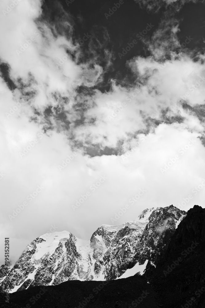 Beautifull valley with snow mountains in the clouds, black and white 