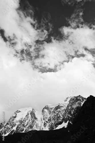 Beautifull valley with snow mountains in the clouds, black and white  © Yauhenia