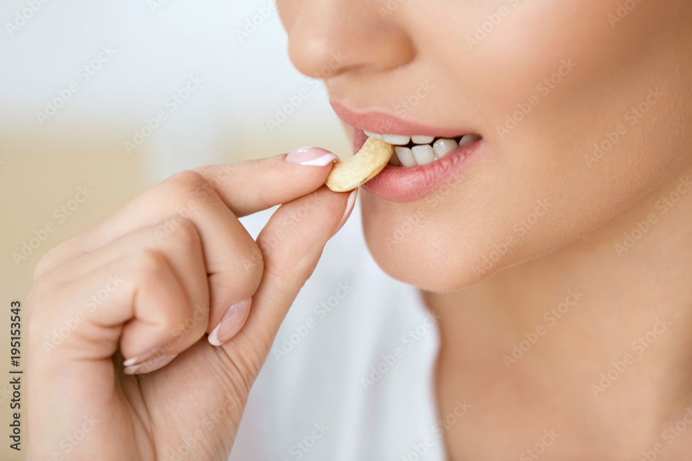Woman Eating Nuts. Closeup Of Female Mouth Biting Nut. Woman Eating Nuts. Closeup Of Female Mouth Biting Nut.