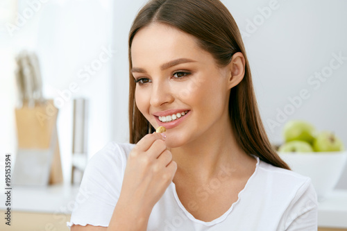 Woman Eating Healthy Diet Food In Kitchen