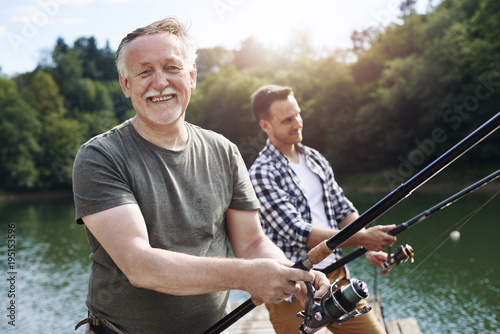 Fotografie, Obraz Portrait of cheerful senior man fishing .