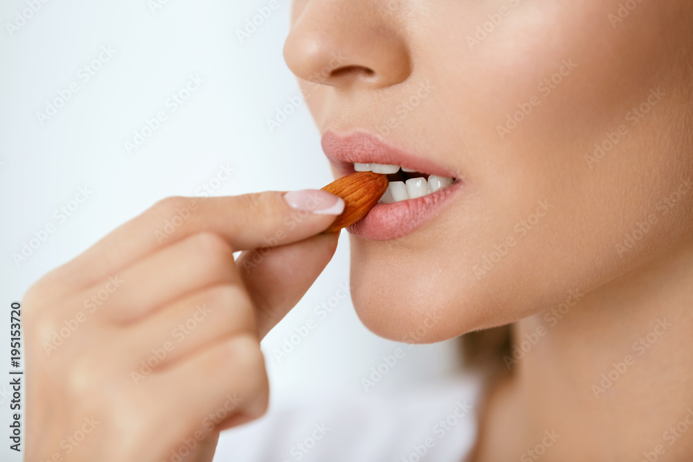 Woman Eating Nuts. Closeup Of Female Mouth Biting Nut. Woman Eating Nuts. Closeup Of Female Mouth Biting Nut.