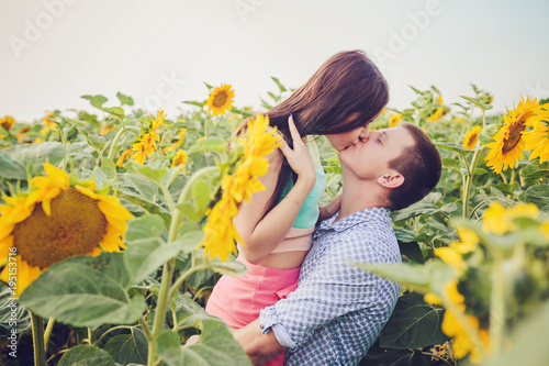 girl and man in a field of sunflowers
