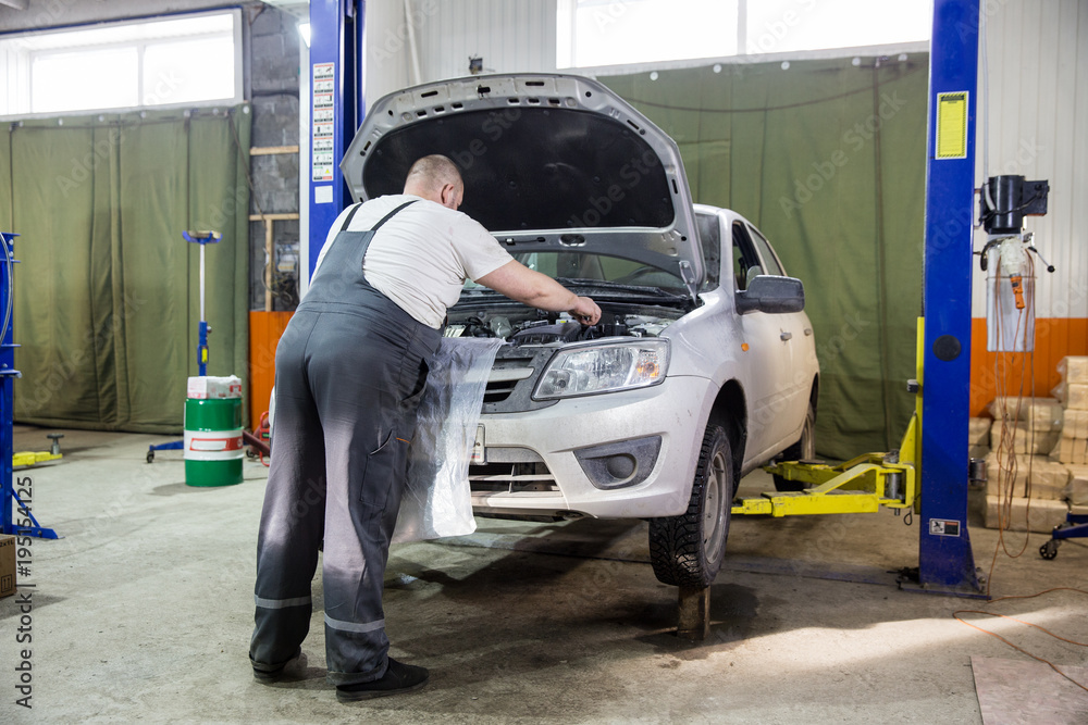 The car on the lift. Change engine oil and transmission inspection