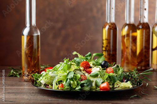 Green salad and olive oil with spices.