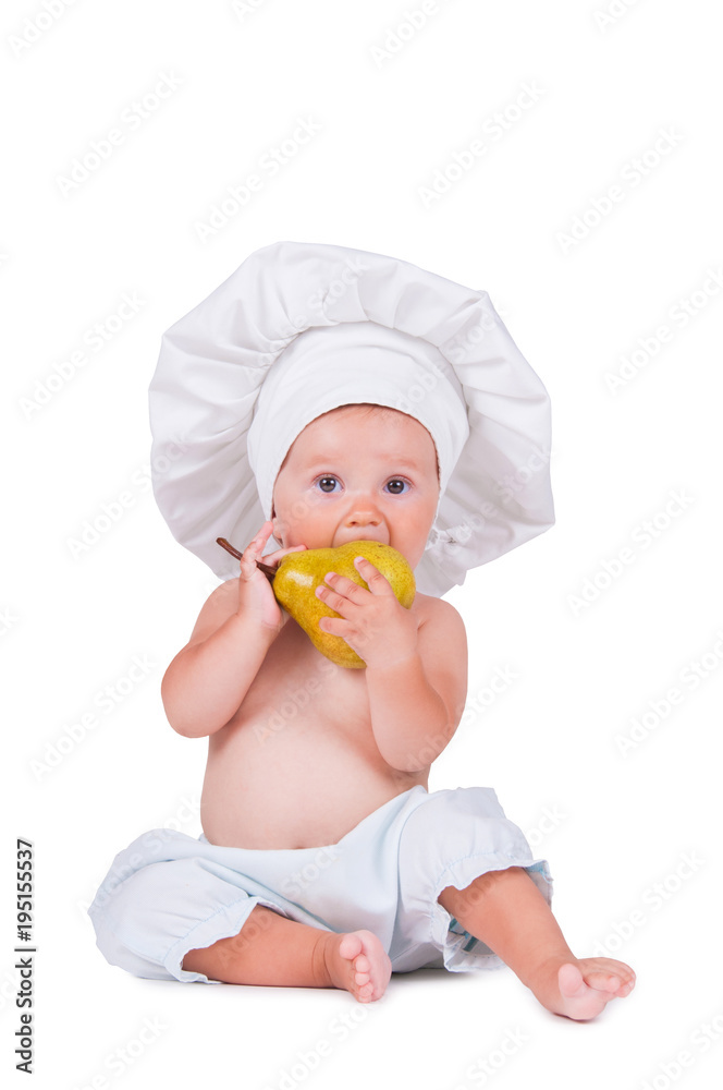Cheerful little child with a pear in his hands in a chef suit on a white background. Cheerful little child with a pear in his hands in a chef suit on a white background.