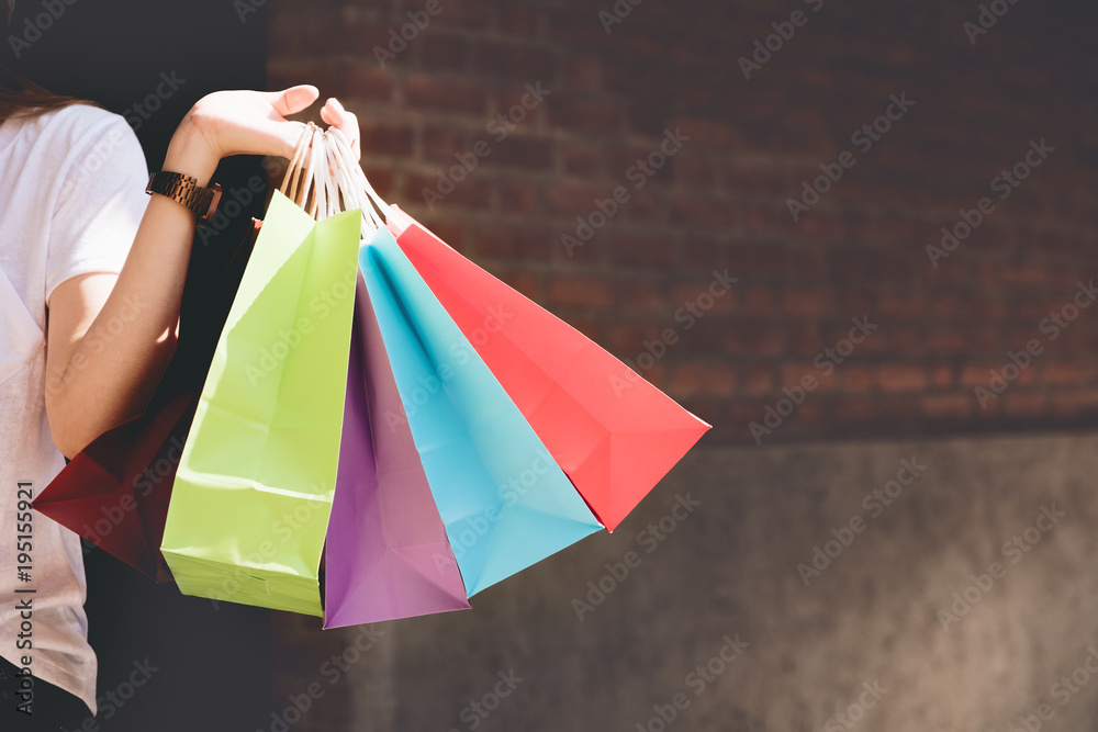 Closeup of woman holding shopping colorful of shopping bags on the street with copy space - Shopping Concept