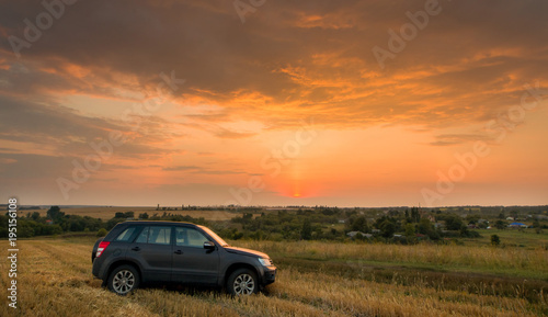 Road car on a field at sunset © Alex