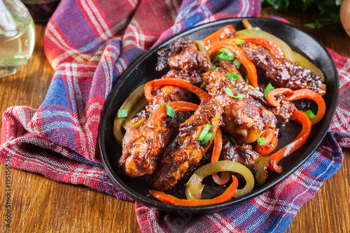 Chinese chicken wings with vegetables in sweet and sour sauce