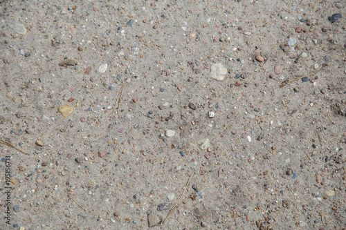 Surface of sandy shore with small pebbles