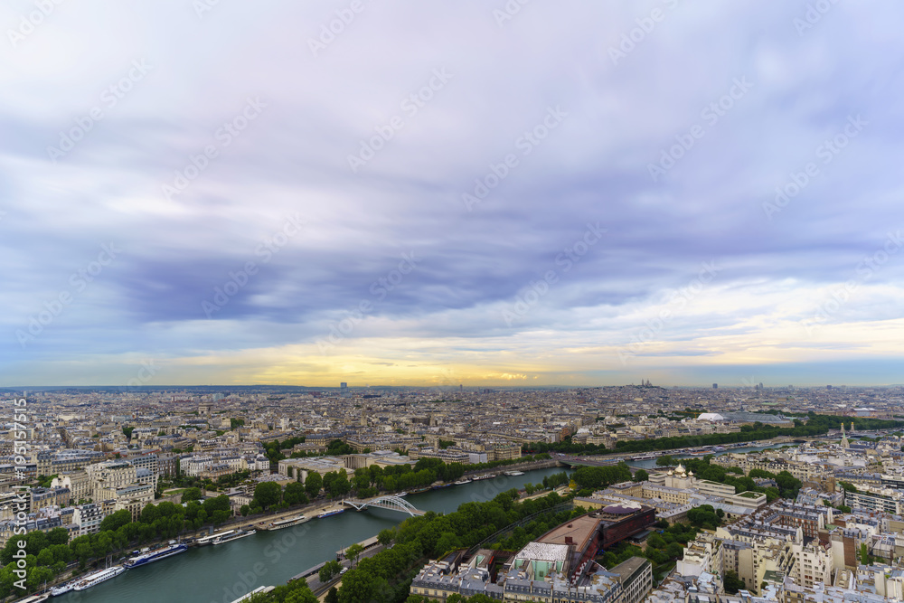 Beautiful cityscape of Paris from The Eiffel Tower viewing Basilica of the Sacred Heart of Paris in distance in twilight ,  France