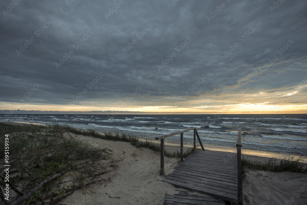 Sunset on the sea from sand beach on the Curonian spit