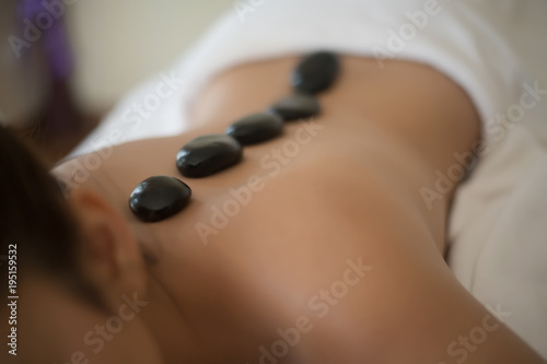 Beautiful woman spa hot stone massage beauty Treatments.
