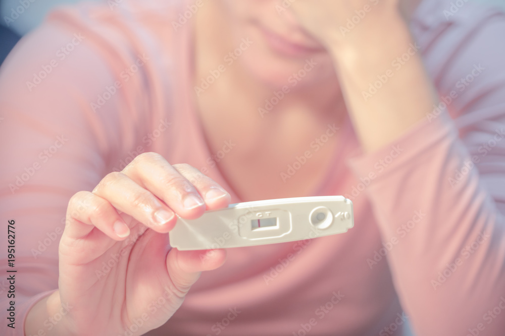 soft focus on the negative pregnancy test result hold on sad women hand soft focus on the negative pregnancy test result hold on sad women hand