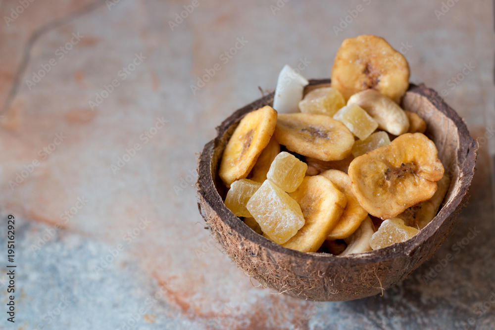 candied fruits, cashews and dried bananas in coconut shell candied fruits, cashews and dried bananas in coconut shell