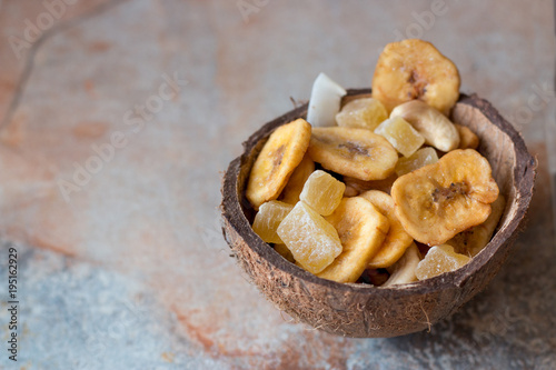 candied fruits, cashews and dried bananas in coconut shell