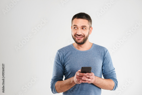 Cheerful man chatting by mobile phone.