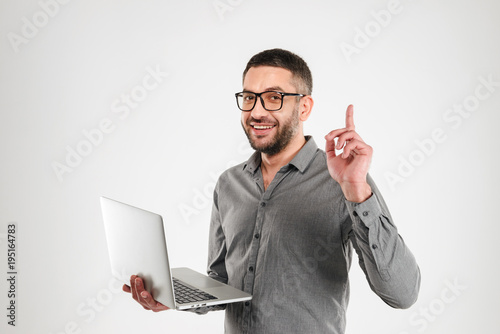 Cheerful man have an idea using laptop computer.