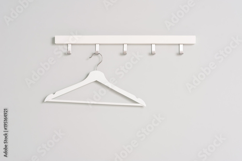 White Clothes hanger on a gray wall background