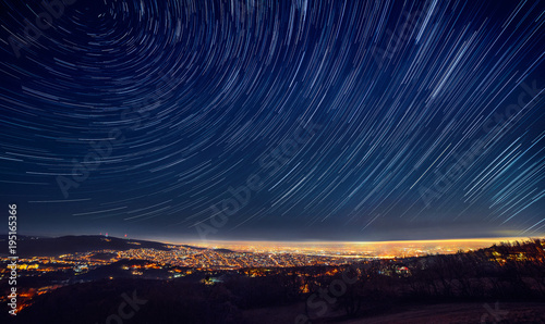 Night sky star trail over the city