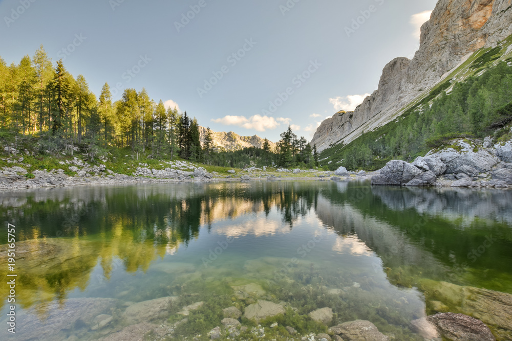 Stunning early morning view of Double Lake (Dvojno jezero) and Triglav Lakes Lodge (Koča pri Triglavskih jezerih) in the background, located in Triglav National Park in the Julian Alps,  Slovenia.