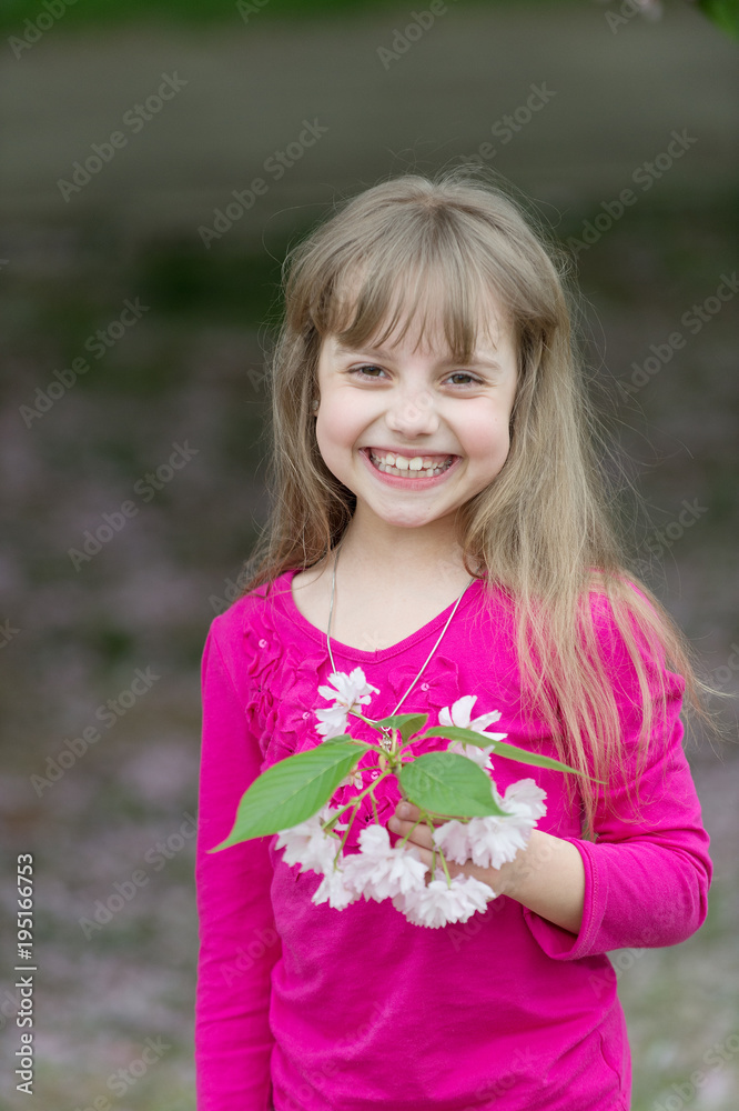 Small baby girl hold spring sakura flower Small baby girl hold spring sakura flower