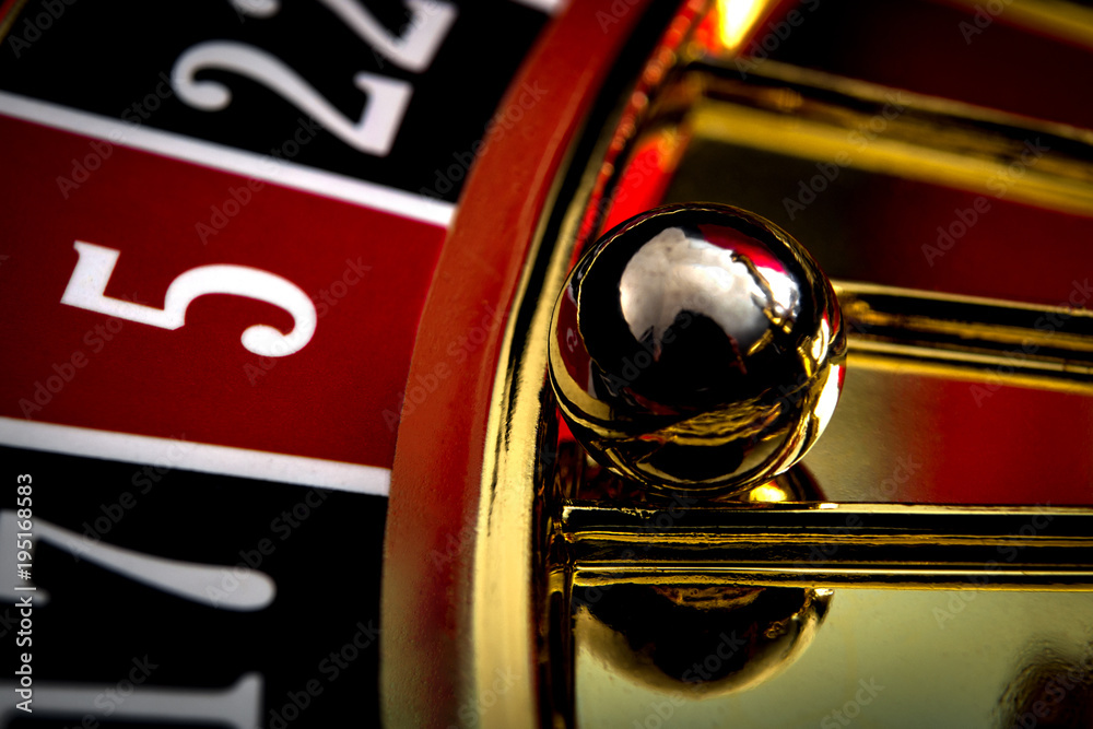 Naklejka premium Games of chance, nightlife and casino gambling concept with a macro close up on the roulette ball in the wheel that indicates five red as the winning number
