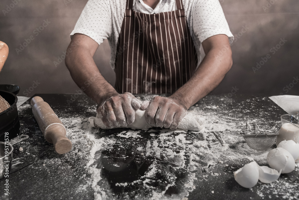 Man preparing buns at table in bakery Man preparing buns at table in bakery