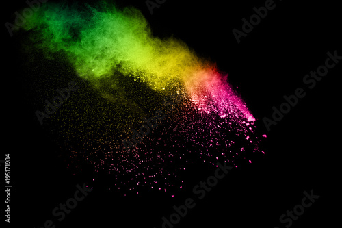 Abstract multicolored powder explosion on black background. Freeze motion of color dust particles splash. Painted Holi.