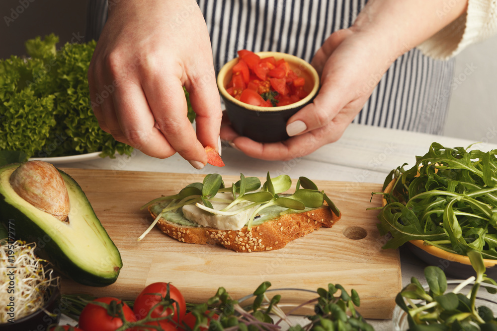 Feamale hands making healthy bruschettas for right snack Feamale hands making healthy bruschettas for right snack