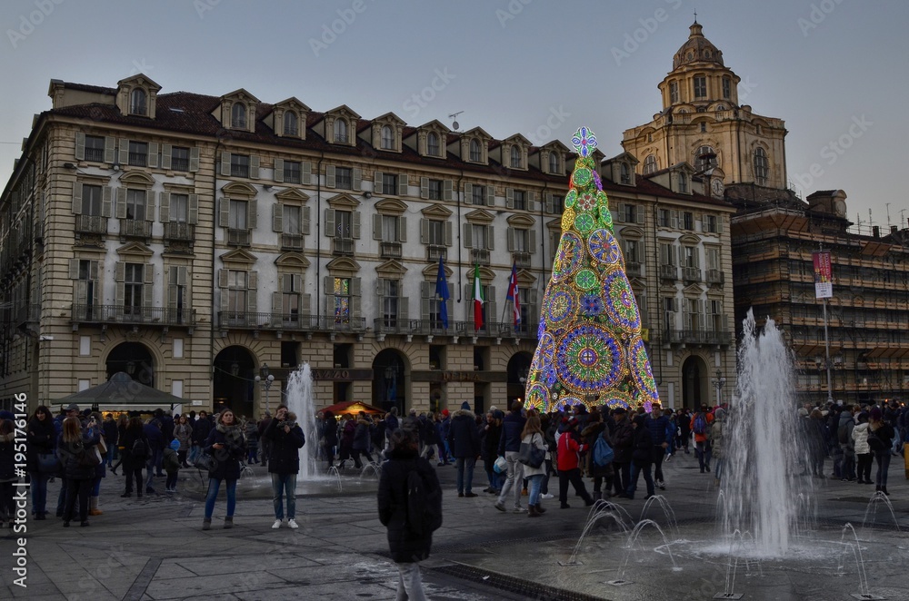 Naklejka premium Turin, Italy, Piedmont, December 8 2017. Piazza Castello adorned with its characteristic Christmas tree, fountains and tourists