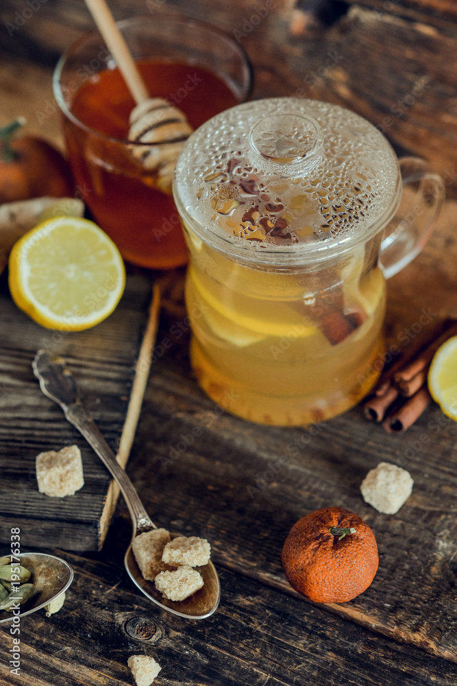 Vitamin tea with lemon and honey, ginger and spices. The concept of spring beriberi and colds. on a wooden table Vitamin tea with lemon and honey, ginger and spices. The concept of spring beriberi and colds. on a wooden table