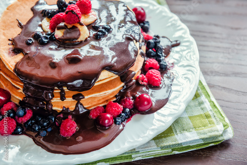 delicious pancakes with chocolate and berries