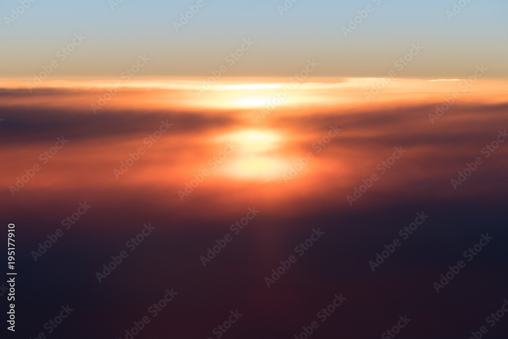 Beautiful sunset or sunrise above clouds from airplane perspective