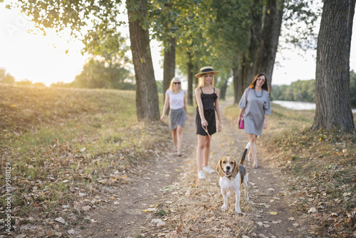 Adventurous sisters with their beagle dog