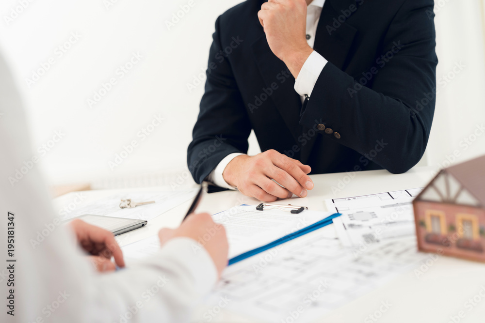Conclusion of a contract for purchase of draft with realtor. Close-up photo of contract and draft. Conclusion of a contract for purchase of draft with realtor. Close-up photo of contract and draft.