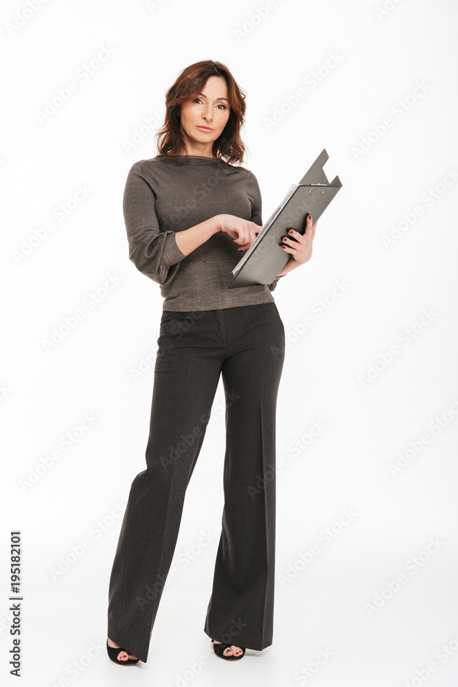 Woman standing isolated holding clipboard folder. Woman standing isolated holding clipboard folder.