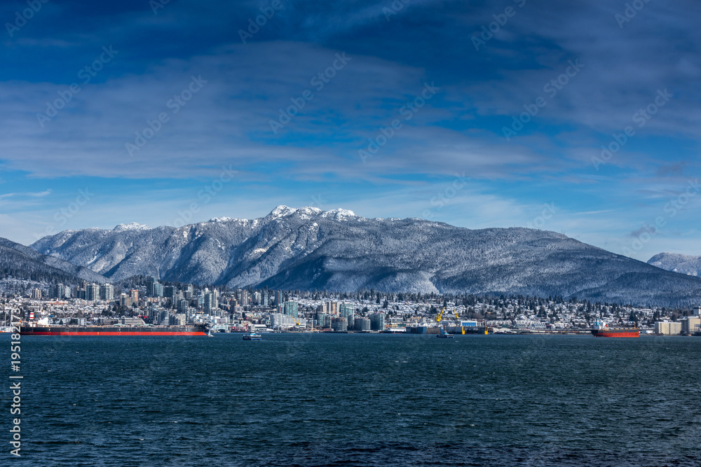 Tanker and Rocky Mountains, North Vancouver, British Colombia, Canada.