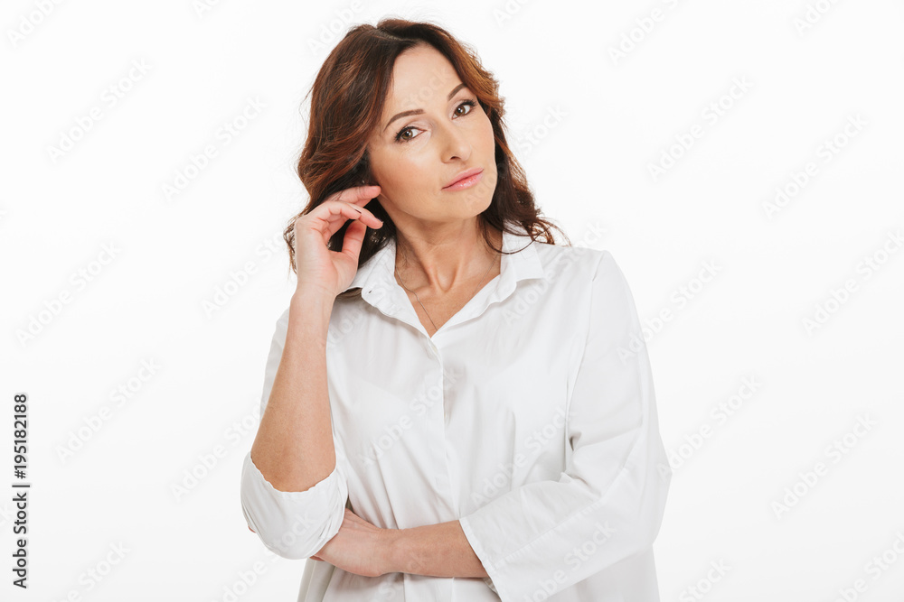 Portrait of charming adult woman 40s posing at camera with adorable look, isolated over white background in studio Portrait of charming adult woman 40s posing at camera with adorable look, isolated over white background in studio