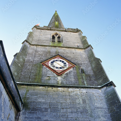 Coloufully decorated clock face on the church tower at Painswick, Gloucestershire, UK. photo